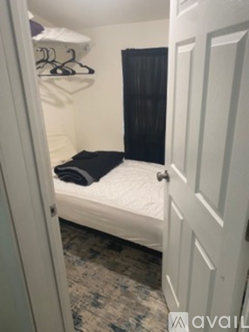A small bedroom with a bed and a closet.