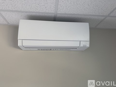 A white air conditioner unit is mounted on a wall.