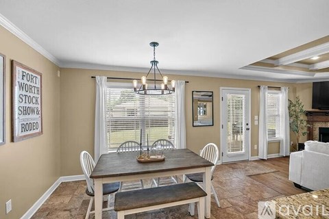 A dining room with a wooden table and chairs.