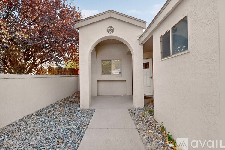 A small white building with a stone pathway leading to it.
