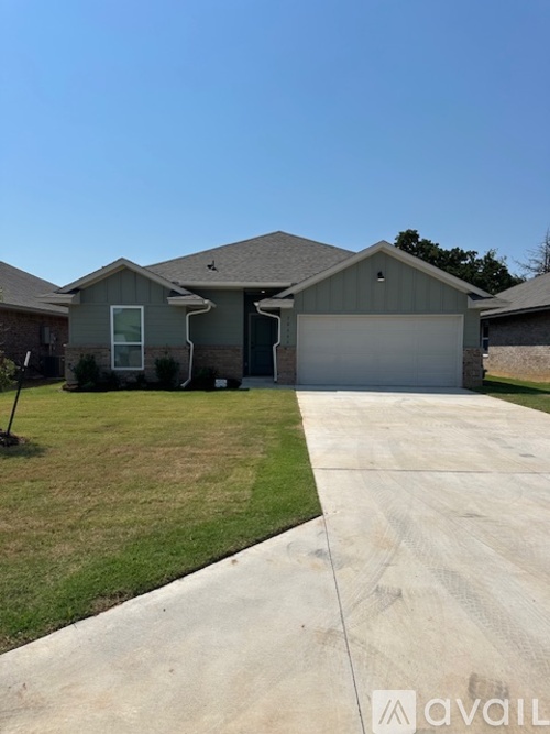 A house with a garage and a driveway in front.