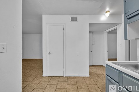 A kitchen area with a sink and a door.