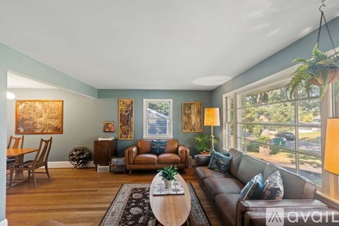 A living room with a brown couch and a coffee table.