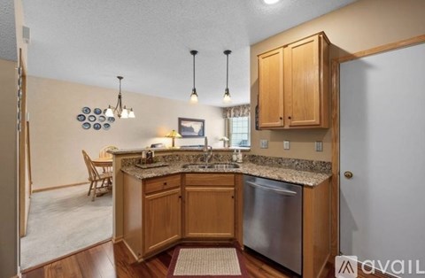 A kitchen with wooden cabinets and granite countertops.