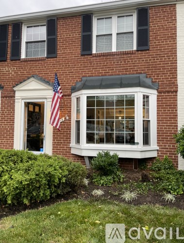 A house with a flag on the front porch.