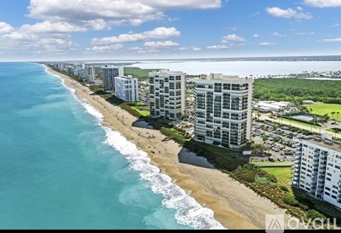 A beachfront view with buildings and a clear sky.