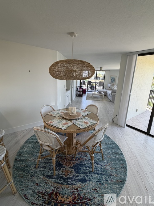 A dining room with a round table and chairs.