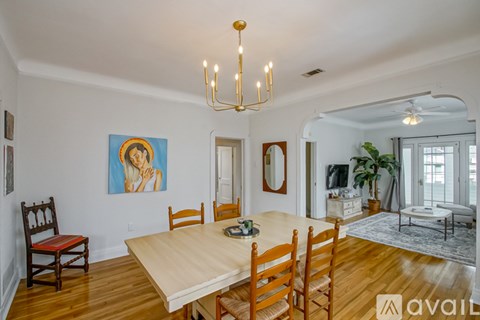 A dining room with a wooden table and chairs.