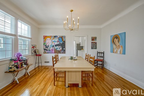 A dining room with a wooden table and chairs.