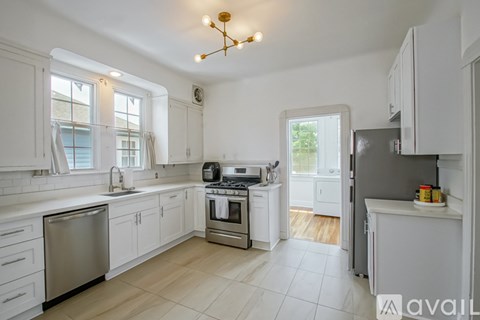 A kitchen with white cabinets and a stainless steel dishwasher.