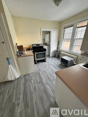A kitchen with a dining table and chairs.