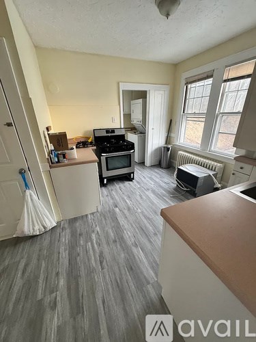 A kitchen with a dining table and chairs.