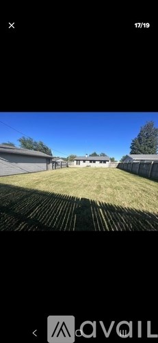 A grassy field with a building in the distance.