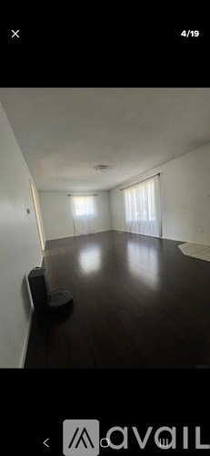 A room with a vacuum cleaner on the floor.