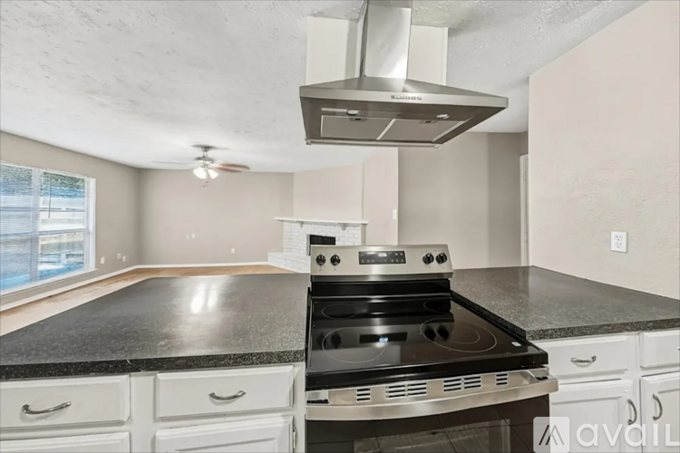 A modern kitchen with a stove top oven and a range hood.