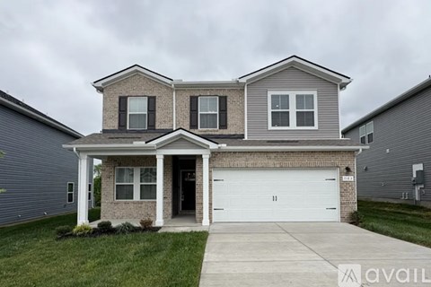 A two-story house with a garage is available for sale.