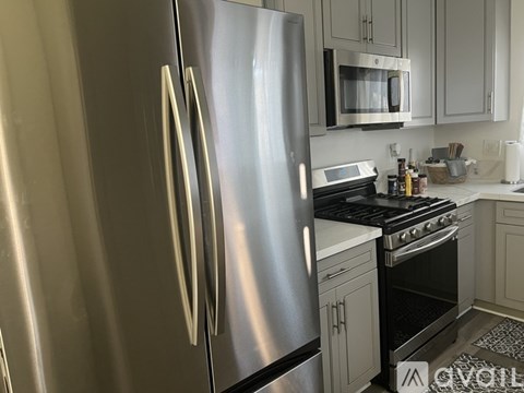 A kitchen with a stainless steel refrigerator and oven.