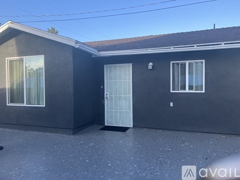 A house with a grey roof and a white door.