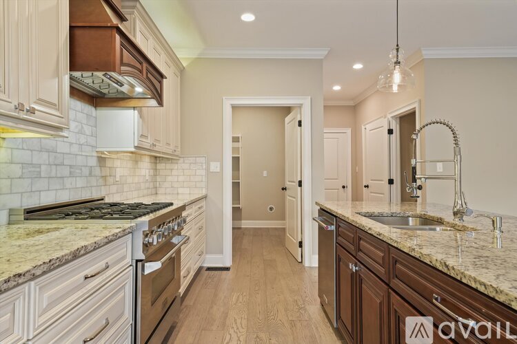 A kitchen with a granite countertop and wooden cabinets.