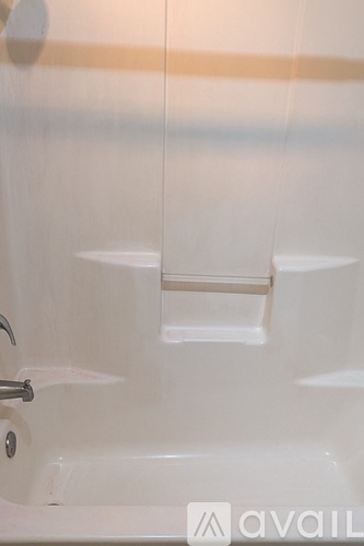 A white sink with a silver faucet and a soap dish.