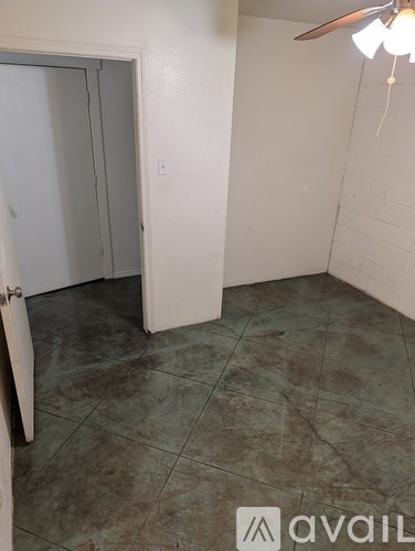 A room with a tiled floor and a ceiling fan.