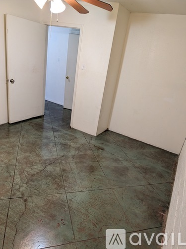 A room with a tiled floor and a ceiling fan.