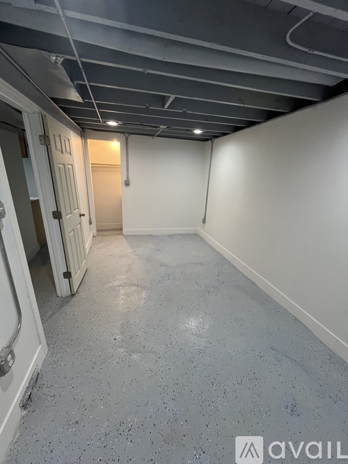 A room with a concrete floor and white walls.