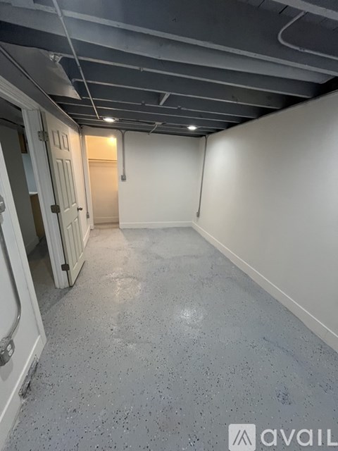 A room with a concrete floor and white walls.