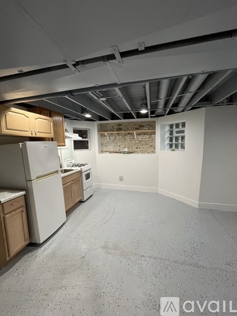 A kitchen with white appliances and wooden cabinets.