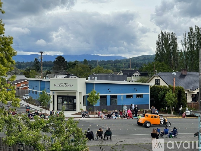 A group of people are gathered outside of a blue building with the words "Medical Center" on it.