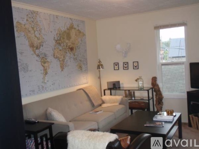 A living room with a world map on the wall.