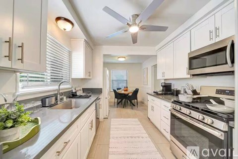 A kitchen with a dining table set for four.