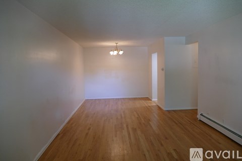 A room with wooden floors and a chandelier.