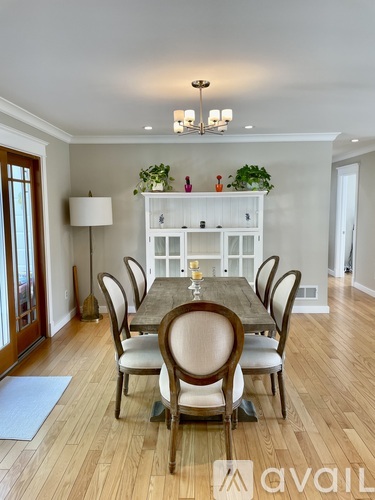A dining room with a table set for six.