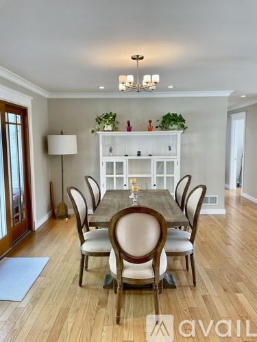 A dining room with a table set for six.