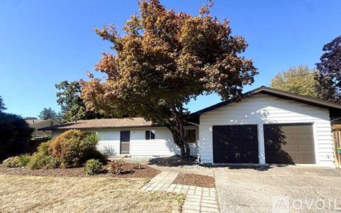 A house with a tree in front of it.