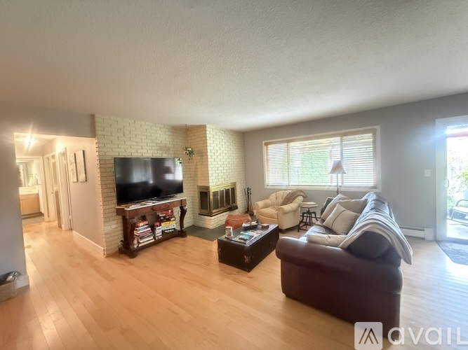 A living room with a brown couch and a television.