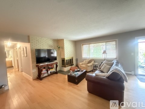 A living room with a brown couch and a television.