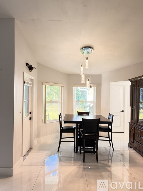 A dining room with a table set for four.