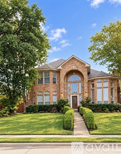 A large house with a red door and a stone archway entrance.