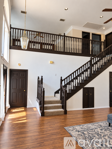 A large open space with a staircase leading to the upper floor.