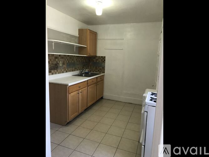 A kitchen with white walls and a white dishwasher.