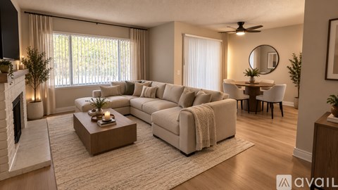 A living room with a fireplace, a couch, a coffee table, and a dining table.