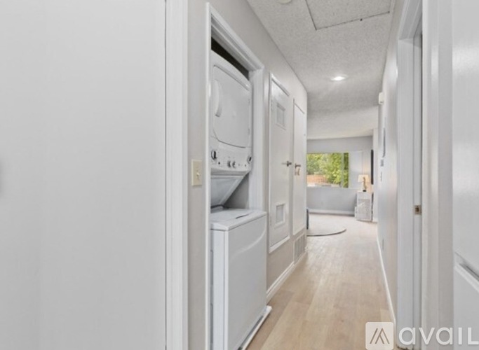 A white kitchen with a refrigerator, oven, and dishwasher.