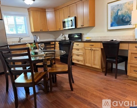 A kitchen with wooden floors and furniture.