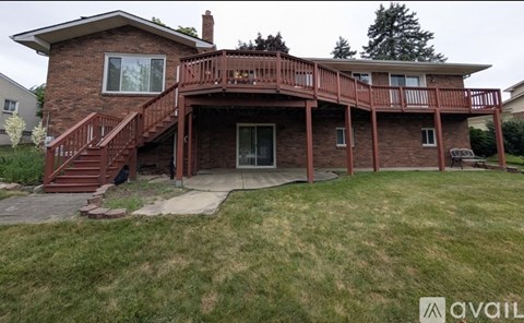 A house with a red brick exterior and a large deck.