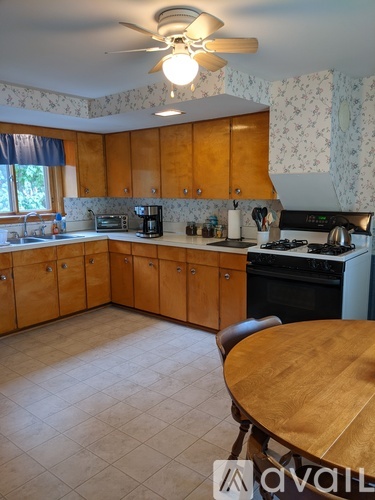A kitchen with wooden cabinets and a table.