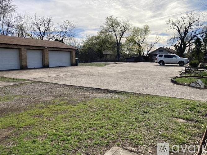 A car is parked in front of a garage.