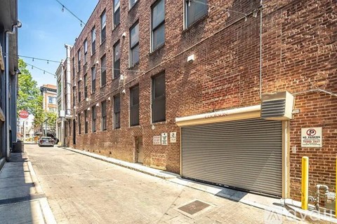 A brick building with a closed garage door on the side.