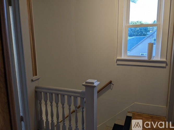 A room with a window and a balcony railing.